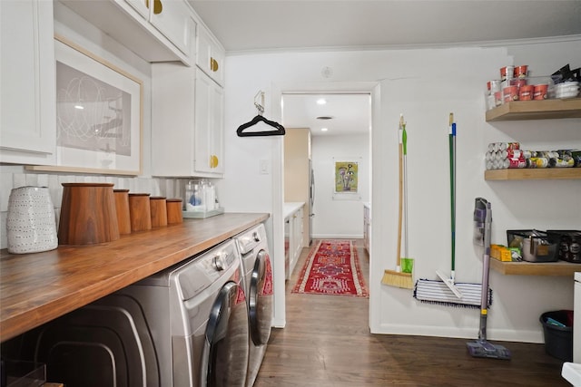 laundry area featuring dark wood-type flooring and washing machine and clothes dryer