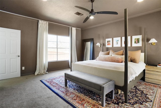 carpeted bedroom featuring ceiling fan, crown molding, and a textured ceiling