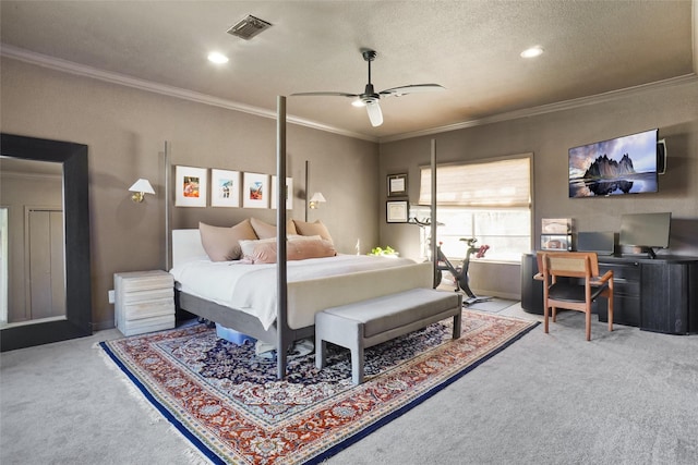 bedroom with ceiling fan, a textured ceiling, carpet, and ornamental molding