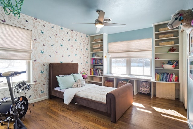 bedroom with ceiling fan and dark hardwood / wood-style floors