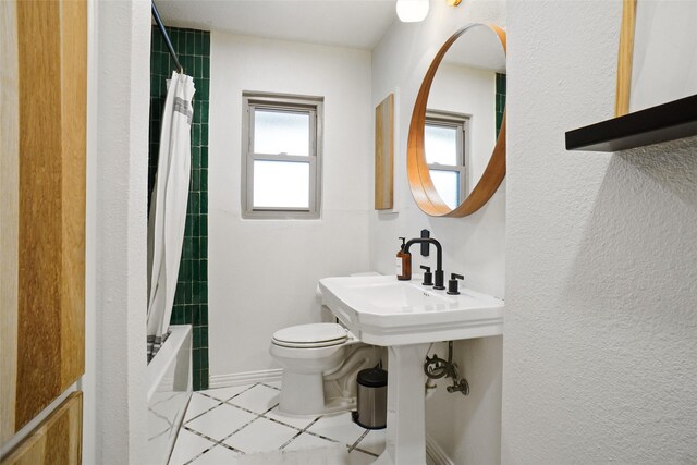 bathroom with a textured ceiling and shower / bathtub combination with curtain