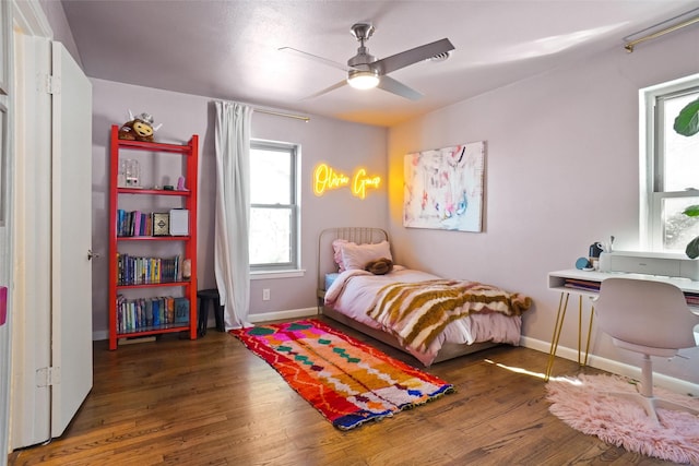 bedroom with ceiling fan and dark hardwood / wood-style flooring