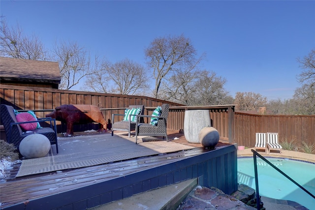 wooden deck with a fenced in pool