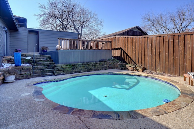 view of pool with a wooden deck