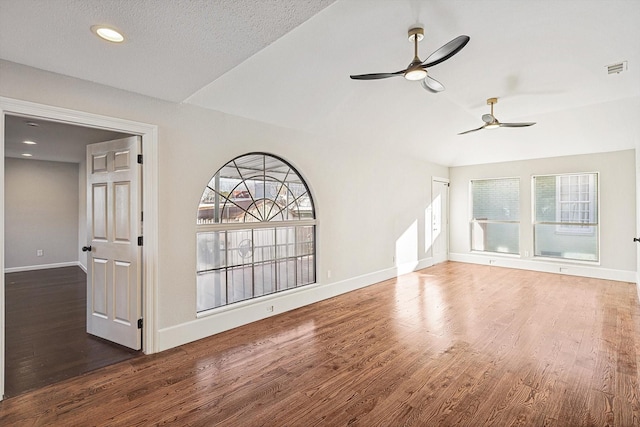 unfurnished living room with ceiling fan, dark hardwood / wood-style flooring, and a textured ceiling