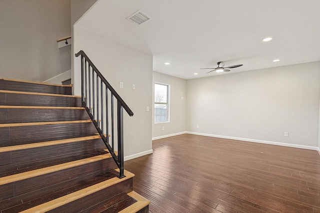 stairway featuring hardwood / wood-style flooring and ceiling fan