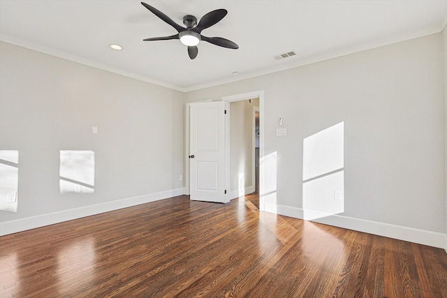 empty room featuring ceiling fan, crown molding, and dark hardwood / wood-style floors