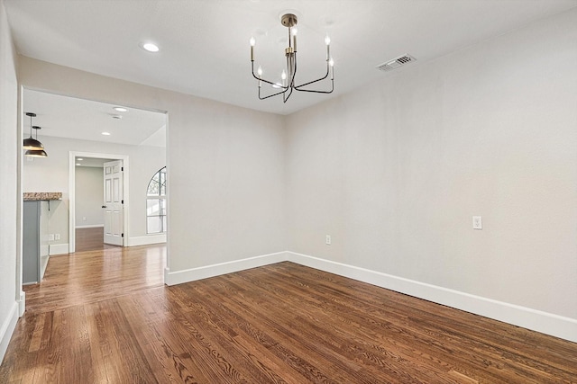 unfurnished dining area with an inviting chandelier and wood-type flooring