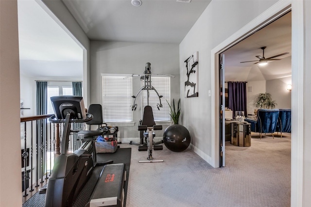 workout area featuring ceiling fan, lofted ceiling, and carpet flooring