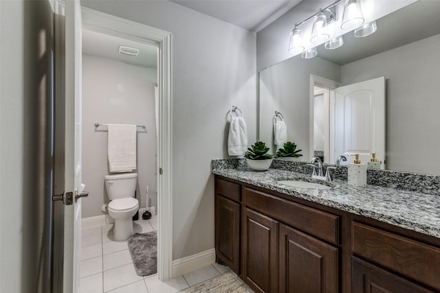 bathroom featuring vanity, tile patterned flooring, and toilet