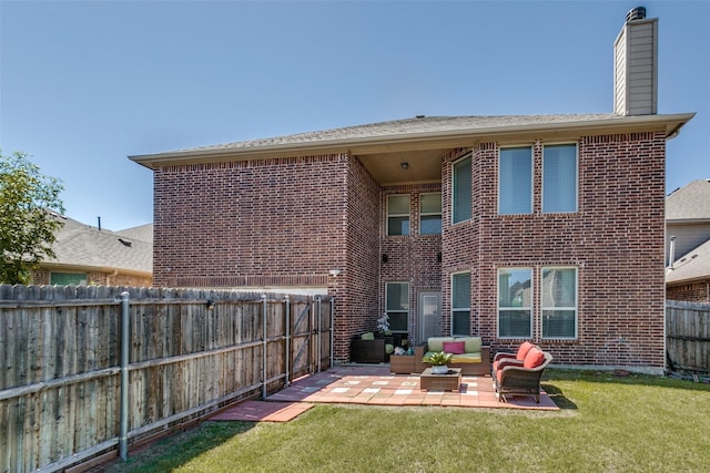 back of property featuring a patio area, an outdoor living space, and a yard