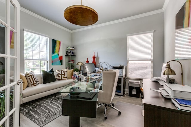 office area with ornamental molding and light hardwood / wood-style floors