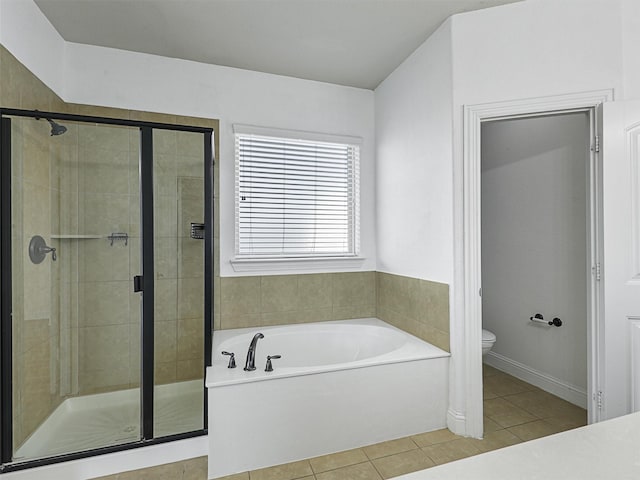 bathroom featuring toilet, separate shower and tub, and tile patterned floors