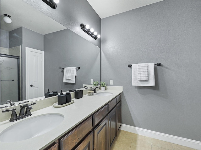 bathroom featuring vanity, an enclosed shower, and tile patterned floors