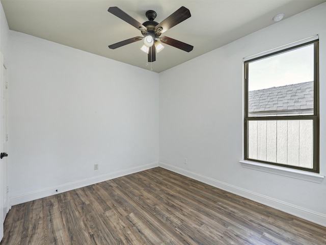 spare room with ceiling fan, dark hardwood / wood-style flooring, and a wealth of natural light