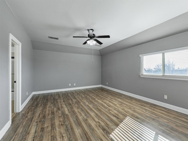 unfurnished room featuring ceiling fan, dark hardwood / wood-style flooring, and lofted ceiling