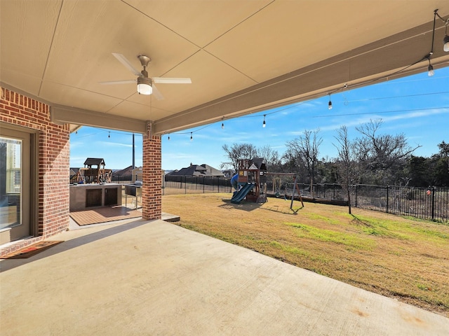 view of patio / terrace with ceiling fan and a playground