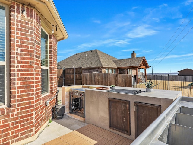 view of patio featuring a bar and area for grilling