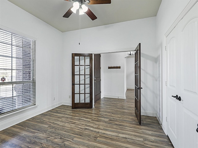 spare room with ceiling fan, french doors, and dark hardwood / wood-style floors