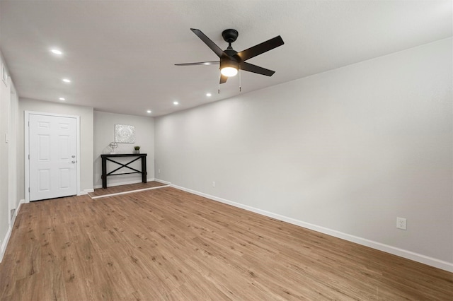 empty room featuring light wood-type flooring and ceiling fan