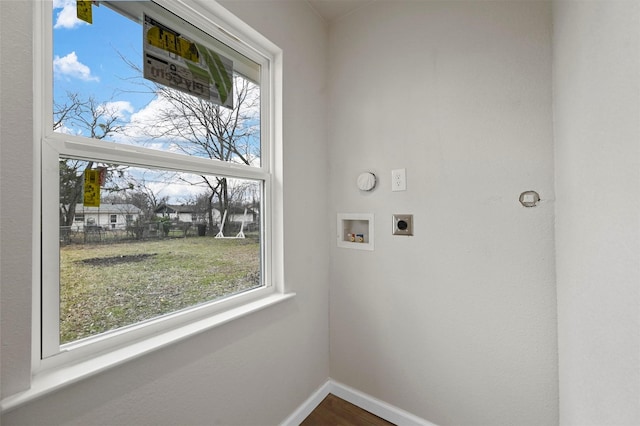 laundry room with washer hookup, a wealth of natural light, hardwood / wood-style flooring, and electric dryer hookup