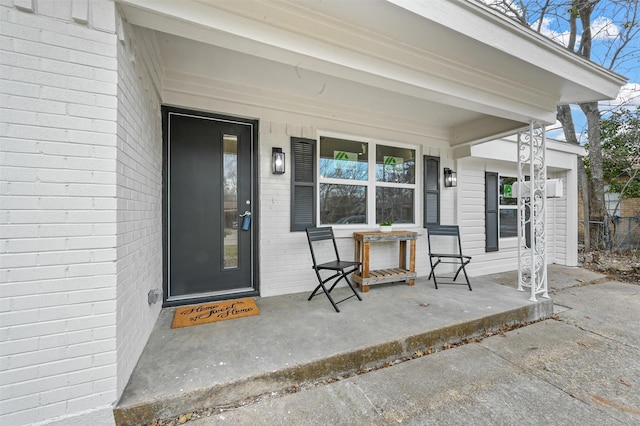 view of exterior entry featuring a porch