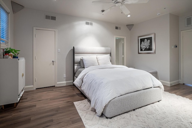 bedroom with ceiling fan and dark hardwood / wood-style floors