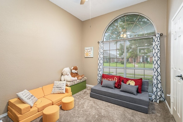 recreation room featuring carpet floors, ceiling fan, and vaulted ceiling