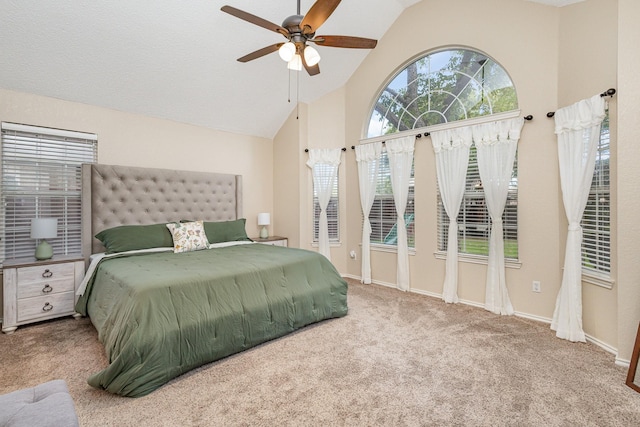 carpeted bedroom with vaulted ceiling and ceiling fan