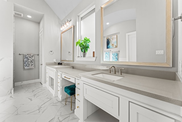 bathroom with vaulted ceiling and vanity