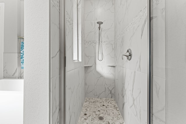 bathroom with a tile shower