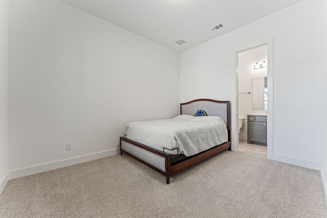 carpeted bedroom with ensuite bath