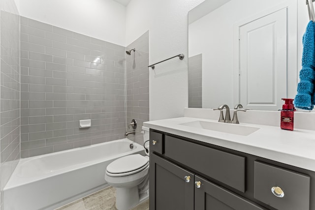 full bathroom featuring toilet, vanity, tile patterned flooring, and tiled shower / bath