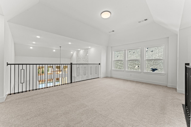 interior space featuring light colored carpet and vaulted ceiling