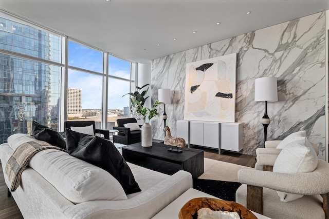 living room with dark hardwood / wood-style flooring, tile walls, and expansive windows