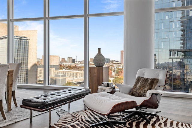 living area featuring a wall of windows and hardwood / wood-style flooring