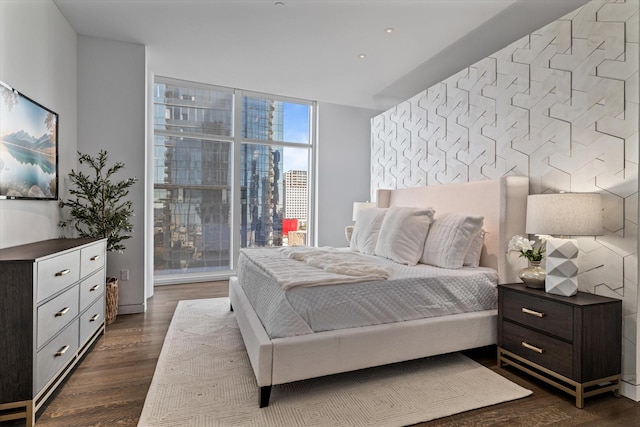 bedroom featuring dark hardwood / wood-style flooring and expansive windows