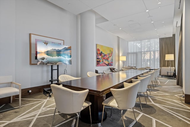 dining area featuring carpet and expansive windows