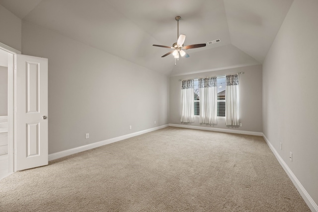 spare room featuring ceiling fan, lofted ceiling, and carpet