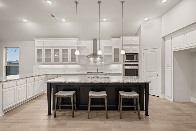 bathroom with vanity, vaulted ceiling, and a healthy amount of sunlight