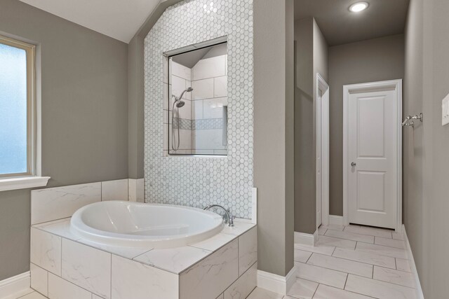 bathroom featuring a tile shower and vanity