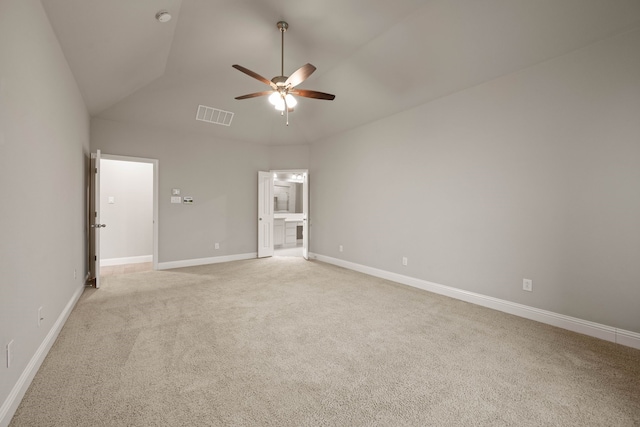 unfurnished bedroom featuring ensuite bath, vaulted ceiling, light colored carpet, and ceiling fan