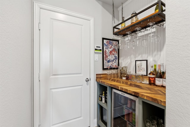 bar featuring butcher block counters and wine cooler