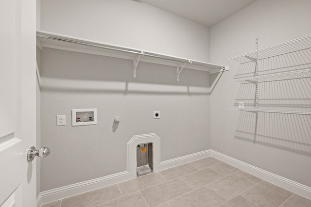 washroom with hookup for a washing machine, gas dryer hookup, electric dryer hookup, and light tile patterned floors