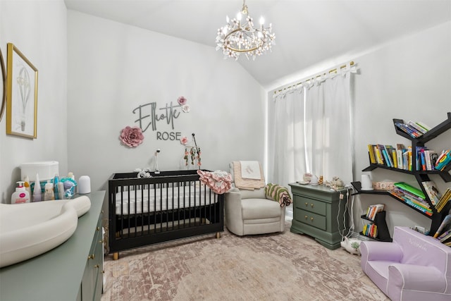 bedroom with sink, a crib, a chandelier, and vaulted ceiling