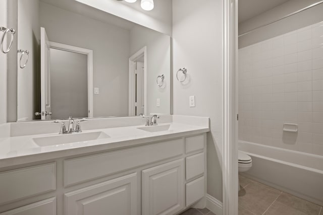 full bathroom featuring tile patterned flooring, vanity, toilet, and tiled shower / bath