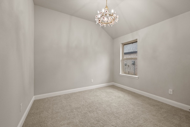 carpeted empty room with vaulted ceiling and a notable chandelier