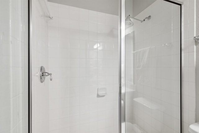 bathroom with a shower with door