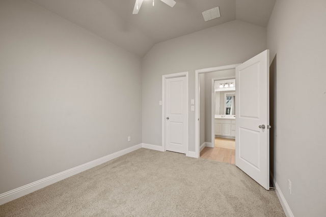 unfurnished bedroom with vaulted ceiling, light carpet, and ceiling fan