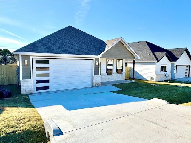 view of front of property featuring a front lawn and a garage